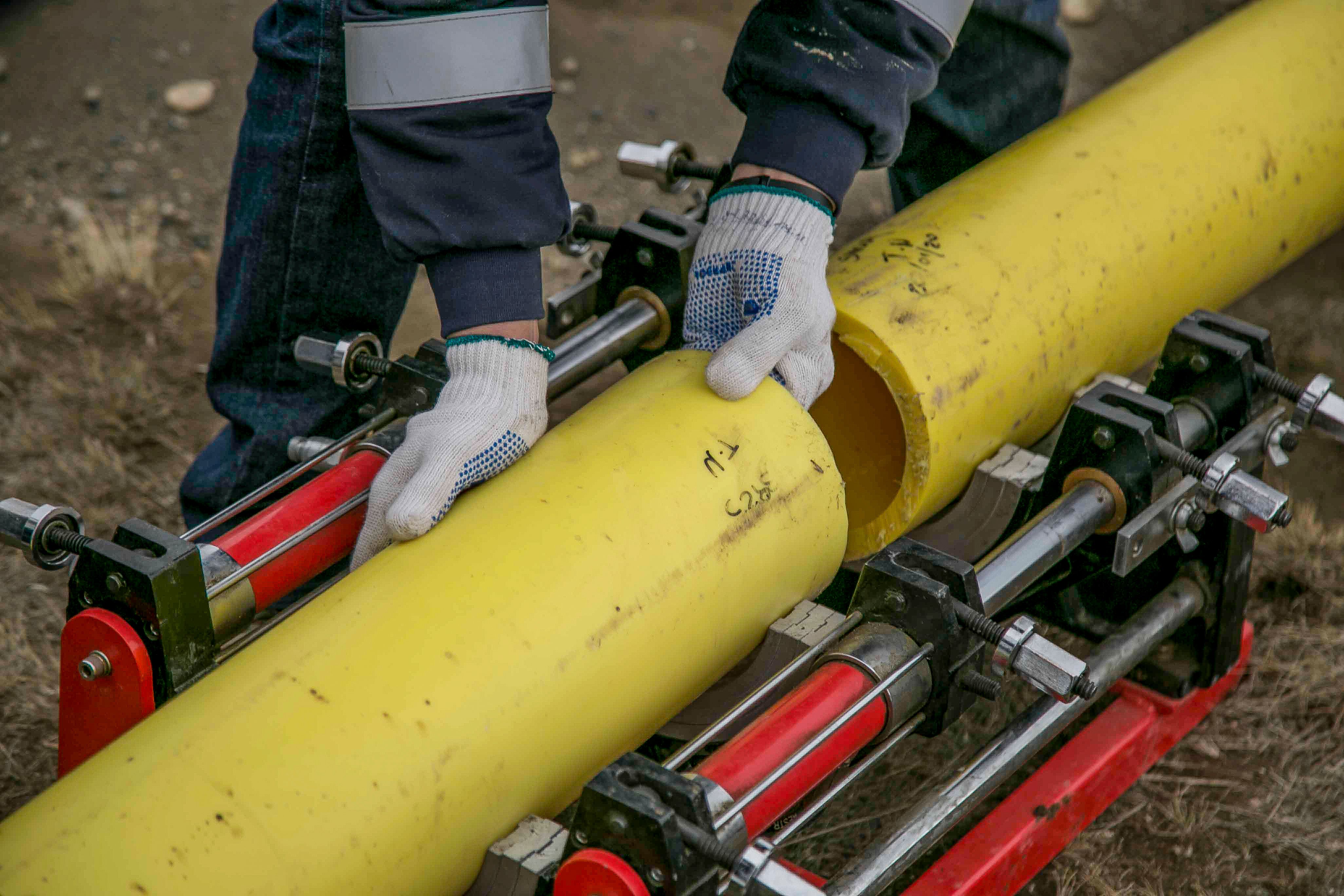 Technician joining plumbing pipes